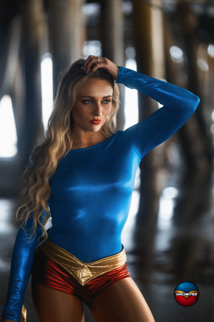 Charisma Davis as UltraGirl, standing among the pilings under a pier