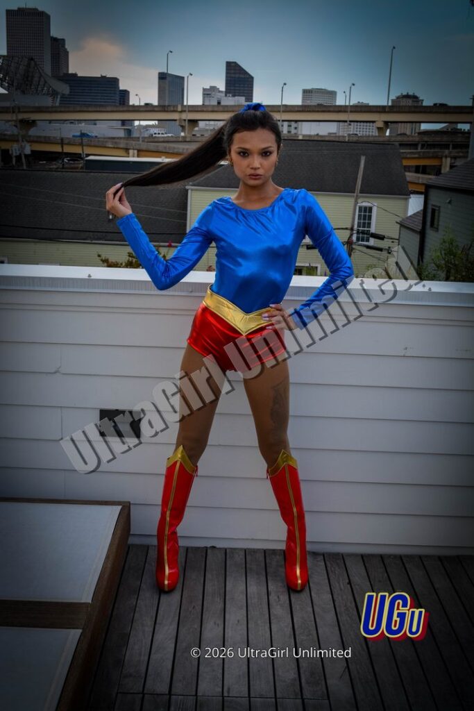Brii Zee as UltraGirl, the rooftop deck with the skyline behind