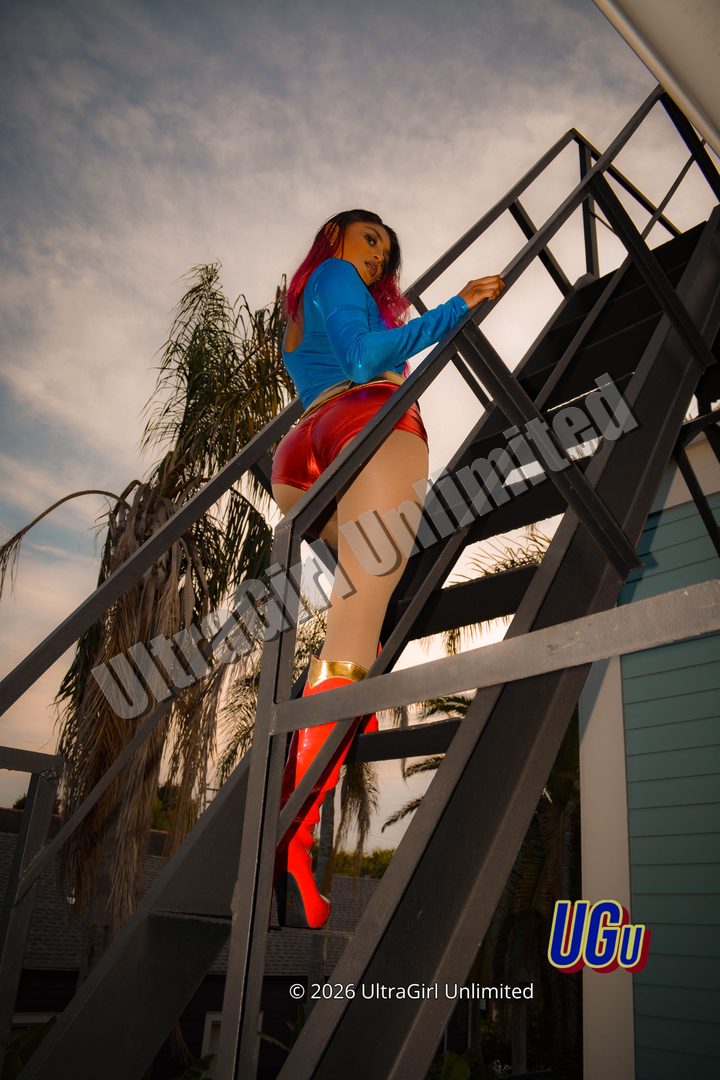 Amanda Persaud as UltraGirl, the fire escape against the evening sky